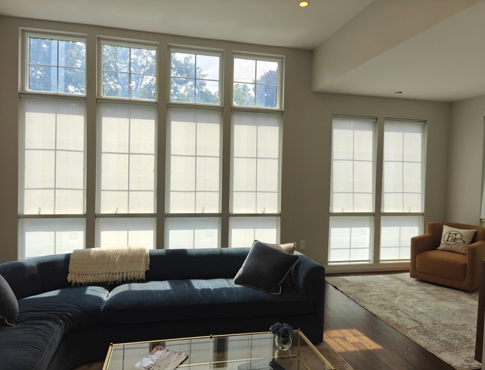 Floor-to-ceiling windows with light-filtering shades in a living room
